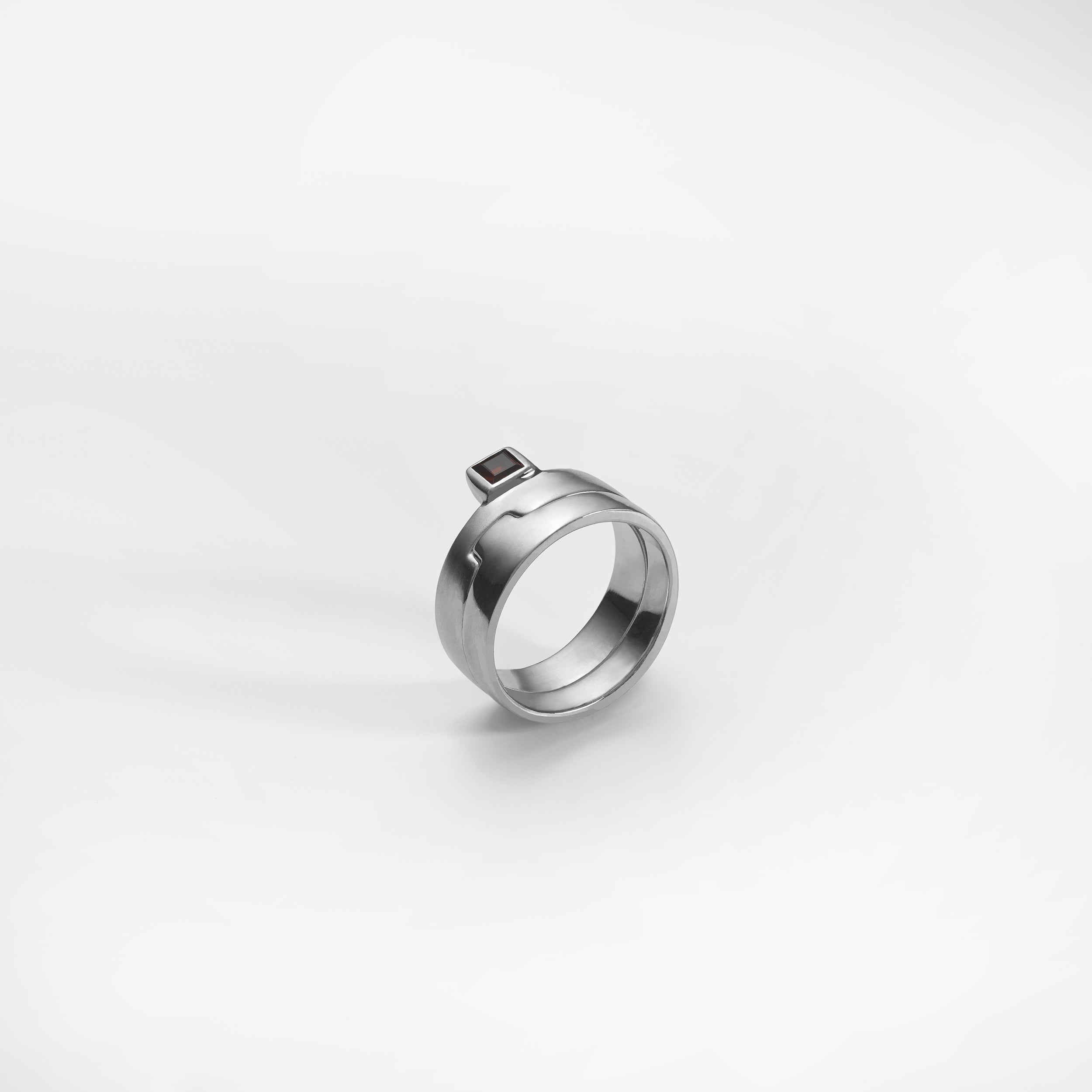 Puzzle ring, sterling silver, set with a red garnet